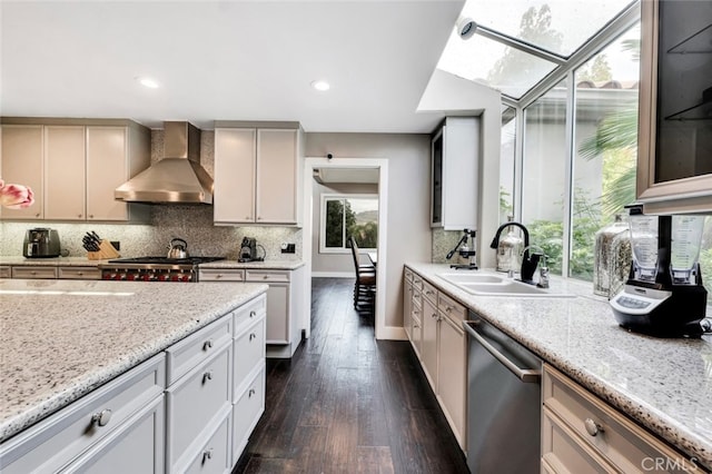 kitchen with dishwasher, sink, backsplash, plenty of natural light, and wall chimney exhaust hood