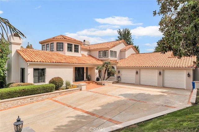 mediterranean / spanish-style home featuring a garage