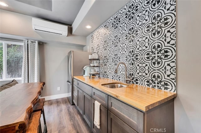 22544 N Summit Ridge Cir, Chatsworth, CA 91311 - kitchen featuring a wall unit AC, wood counters, recessed lighting, dark wood-type flooring, and freestanding refrigerator