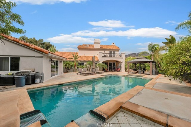 view of pool featuring a grill, a gazebo, and a patio area