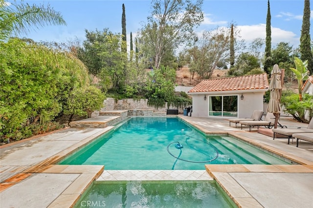 view of pool featuring an outdoor structure and a patio