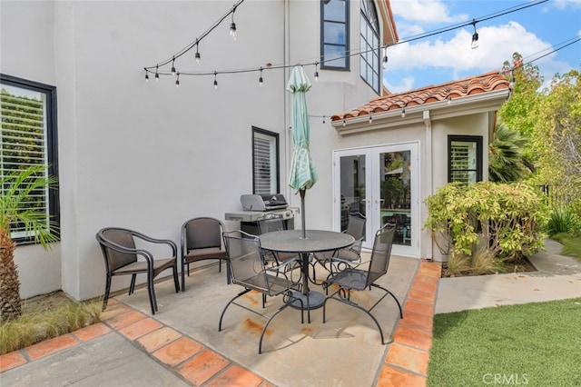 view of patio with area for grilling and french doors