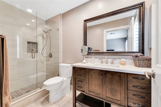 bathroom featuring vanity, toilet, a shower with shower door, and tile patterned flooring