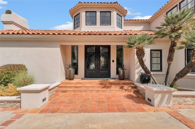 22544 N Summit Ridge Cir, Chatsworth, CA 91311 - property entrance featuring french doors, stucco siding, a tiled roof, and covered porch