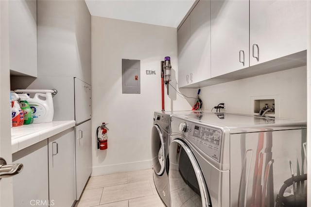 22544 N Summit Ridge Cir, Chatsworth, CA 91311 - washroom with cabinet space, independent washer and dryer, electric panel, and light tile patterned floors