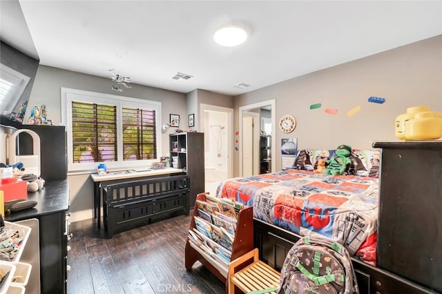 bedroom featuring dark wood-type flooring and ensuite bathroom