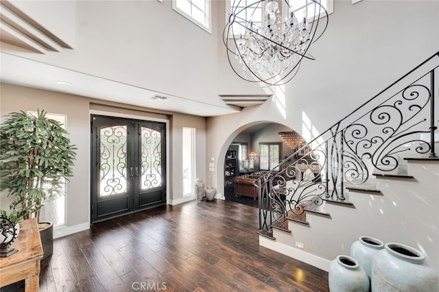 22544 N Summit Ridge Cir, Chatsworth, CA 91311 - foyer entrance with arched walkways, french doors, stairway, a high ceiling, and wood finished floors