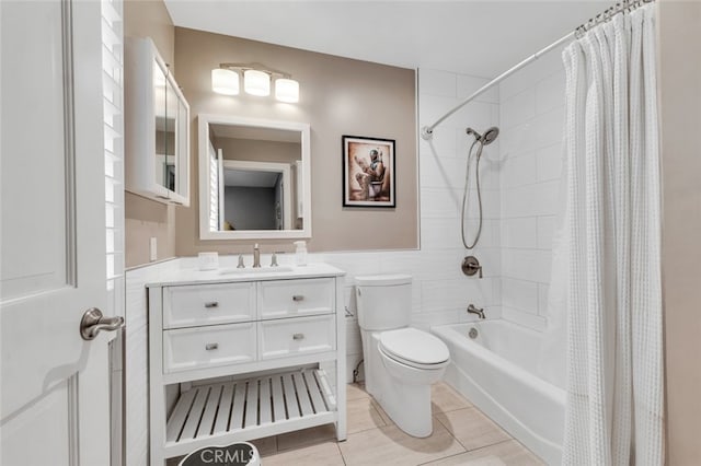 full bathroom featuring toilet, shower / tub combo, tile walls, vanity, and tile patterned flooring