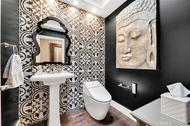 bathroom featuring wood-type flooring and toilet