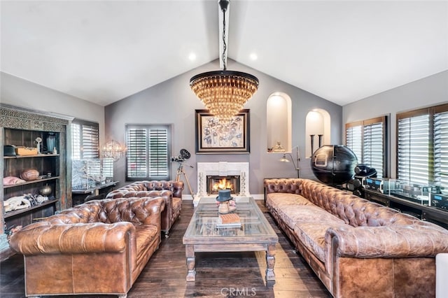 living room featuring vaulted ceiling with beams, an inviting chandelier, and dark hardwood / wood-style floors