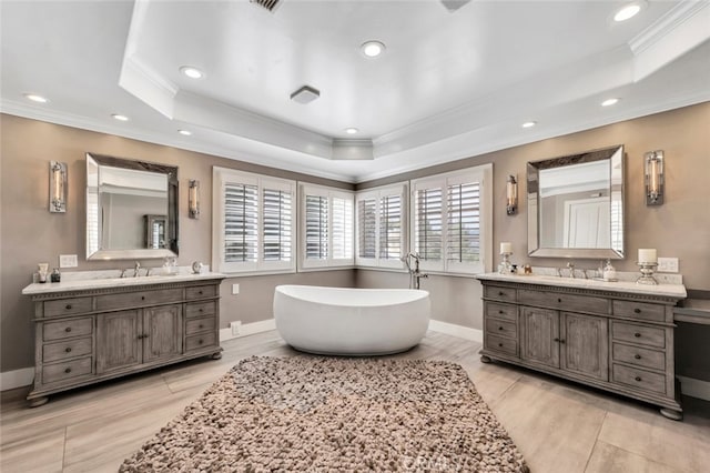 22544 N Summit Ridge Cir, Chatsworth, CA 91311 - bathroom featuring a raised ceiling, ornamental molding, two vanities, a soaking tub, and recessed lighting