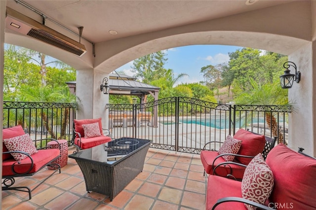 view of patio featuring a fenced in pool, a gazebo, and an outdoor living space