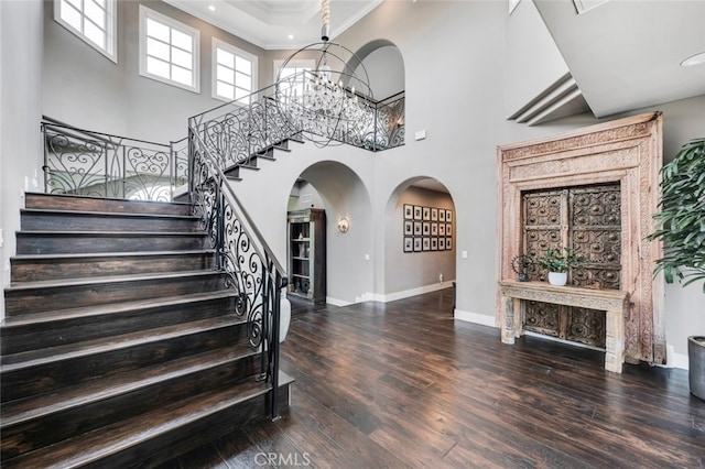 22544 N Summit Ridge Cir, Chatsworth, CA 91311 - foyer entrance with crown molding, wood finished floors, stairs, arched walkways, and a chandelier