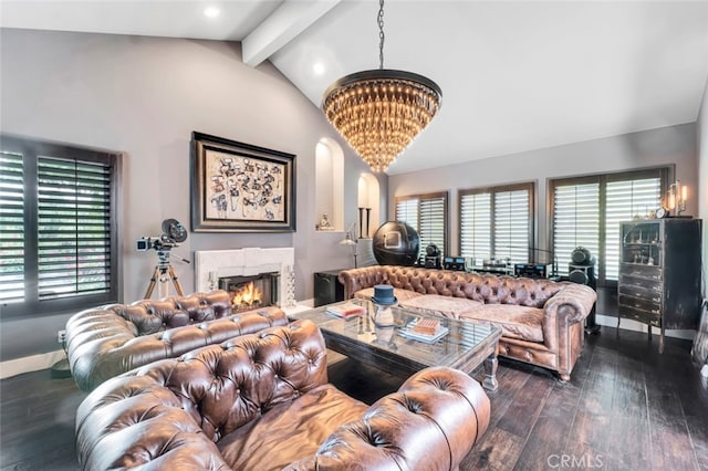 living room featuring vaulted ceiling with beams, dark wood-type flooring, a notable chandelier, and a fireplace