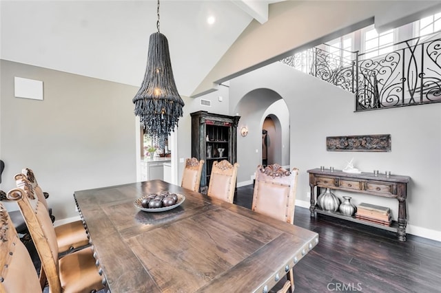 dining area featuring dark wood-type flooring, beam ceiling, high vaulted ceiling, and a notable chandelier