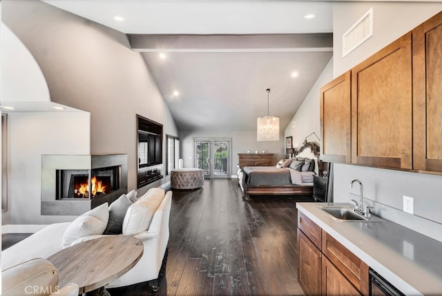 kitchen with dark hardwood / wood-style floors, a multi sided fireplace, beam ceiling, and sink