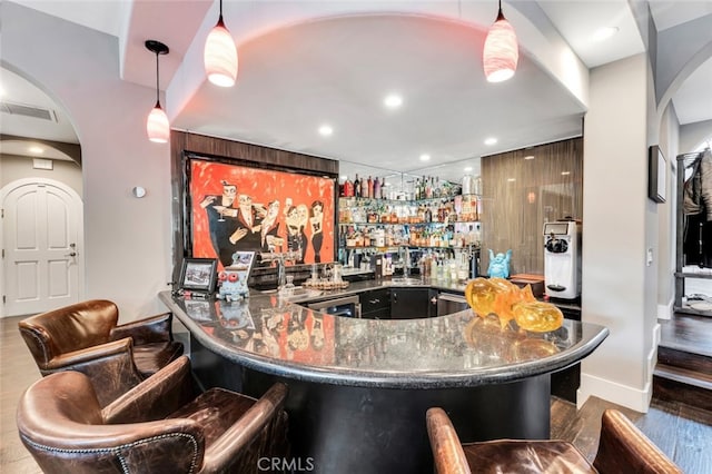 22544 N Summit Ridge Cir, Chatsworth, CA 91311 - indoor wet bar with arched walkways, recessed lighting, hanging light fixtures, and wood finished floors