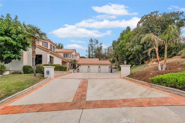 22544 N Summit Ridge Cir, Chatsworth, CA 91311 - mediterranean / spanish house with stucco siding, a tiled roof, and concrete driveway