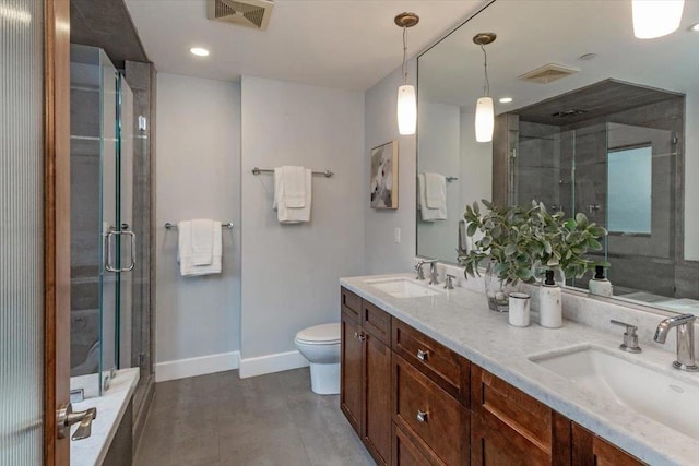 bathroom with vanity, toilet, and a shower with shower door