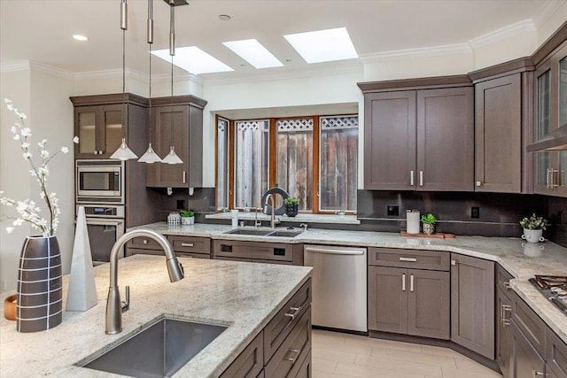 kitchen featuring stainless steel appliances, crown molding, sink, and light stone counters