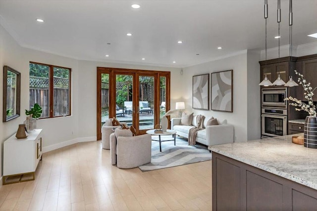 living room featuring crown molding, light hardwood / wood-style flooring, and french doors