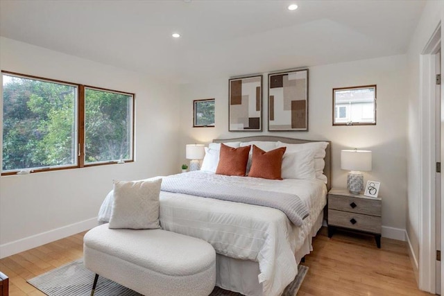 bedroom featuring multiple windows and light wood-type flooring