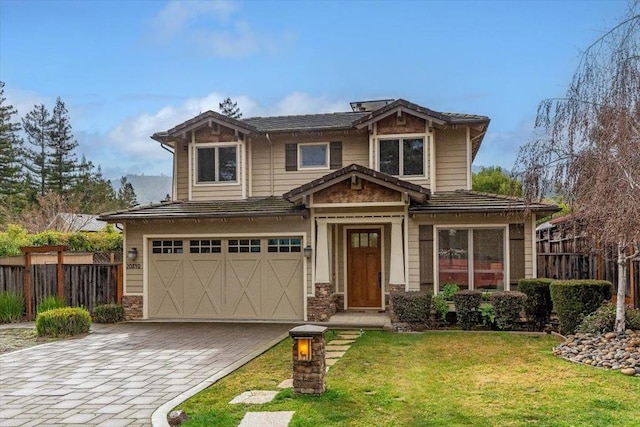 craftsman inspired home with a garage and a front yard