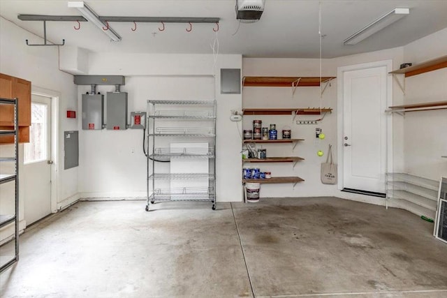 garage with a garage door opener and electric panel