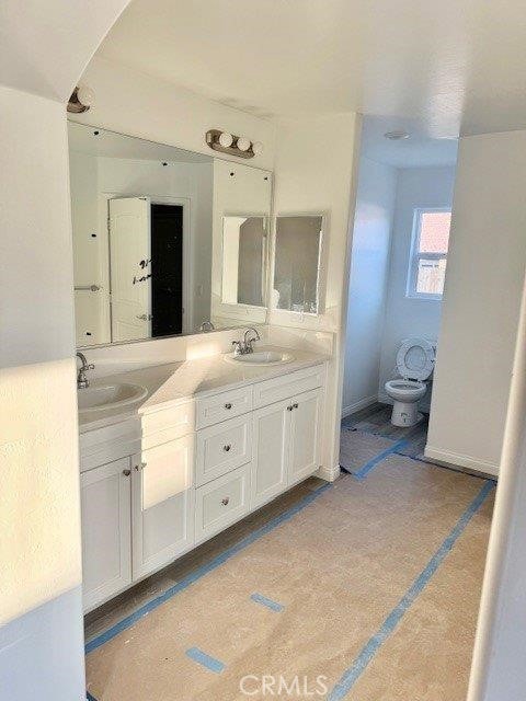 bathroom featuring vanity and toilet