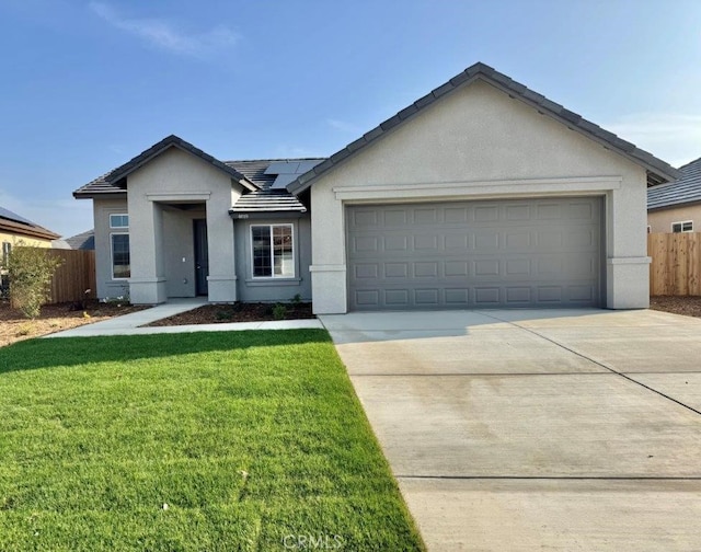 ranch-style home with a garage, a front lawn, and solar panels