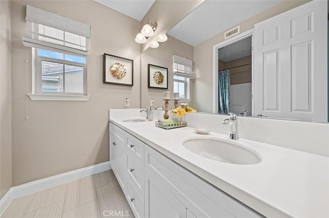 bathroom with tile patterned floors, vanity, toilet, and plenty of natural light