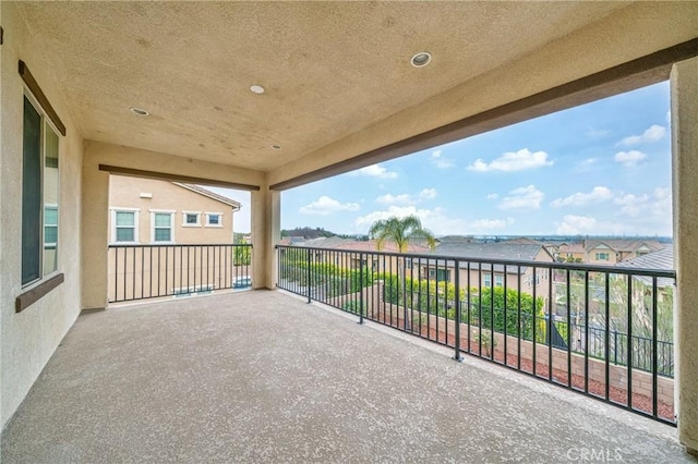 view of patio with a water view and a balcony