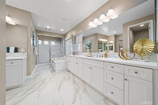 bathroom with vanity and separate shower and tub