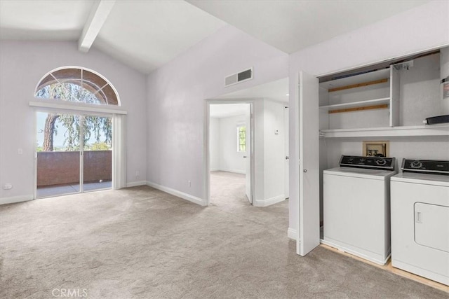 clothes washing area featuring light carpet and washing machine and clothes dryer