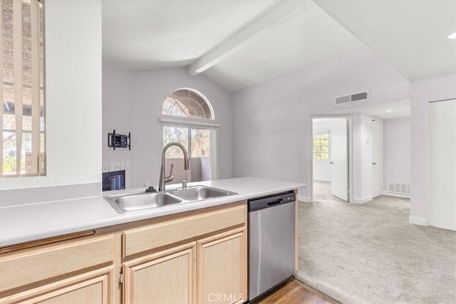 kitchen with vaulted ceiling with beams, sink, light brown cabinets, stainless steel dishwasher, and light carpet