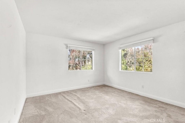 carpeted empty room featuring a healthy amount of sunlight