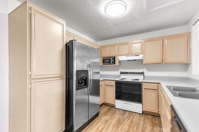 kitchen featuring stainless steel appliances, sink, light brown cabinetry, and light hardwood / wood-style floors