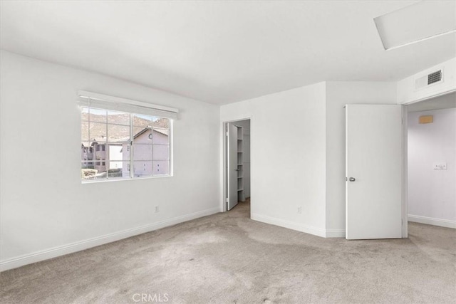 unfurnished room featuring light colored carpet