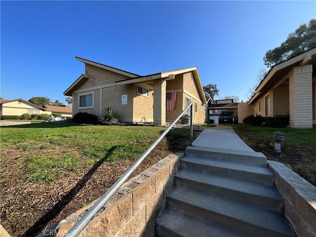 view of home's exterior with a lawn