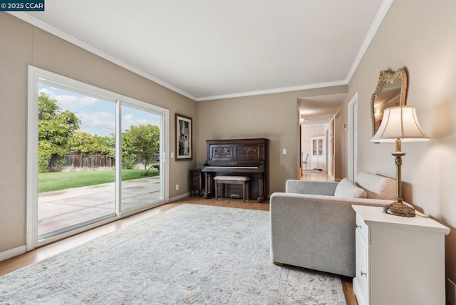 living room featuring crown molding and light wood-type flooring