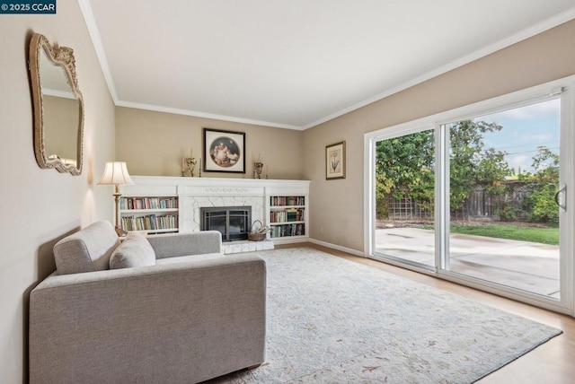 unfurnished living room featuring hardwood / wood-style flooring, ornamental molding, and a high end fireplace