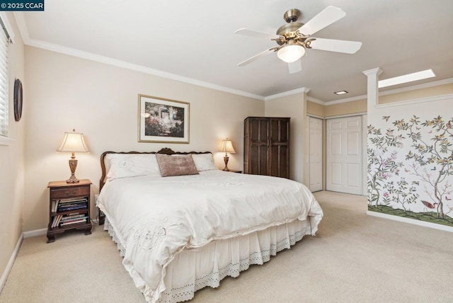 bedroom with crown molding, light colored carpet, ceiling fan, and a closet