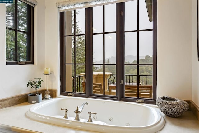 bathroom with a relaxing tiled tub