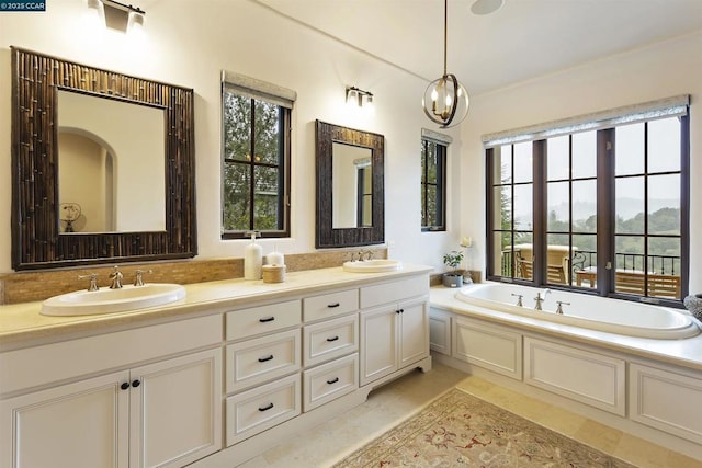 bathroom with tile patterned floors, vanity, and a tub