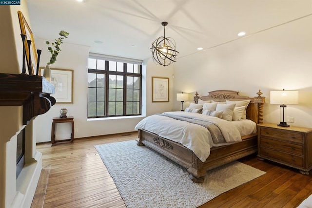 bedroom with an inviting chandelier and light hardwood / wood-style flooring