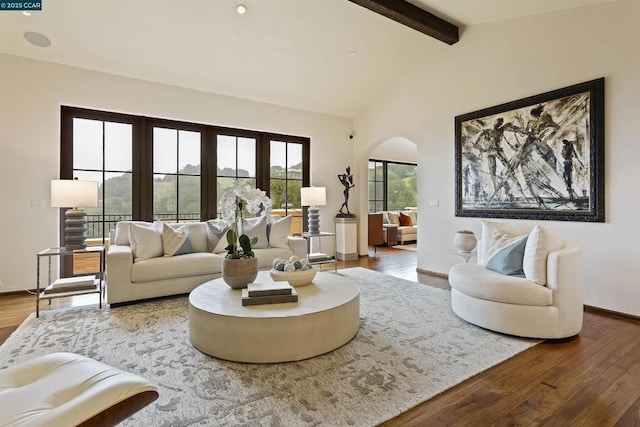 living room with vaulted ceiling with beams and hardwood / wood-style flooring