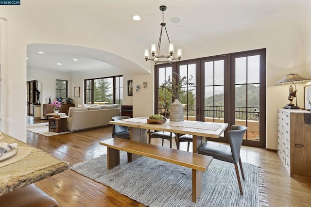 dining space featuring a notable chandelier and light hardwood / wood-style floors