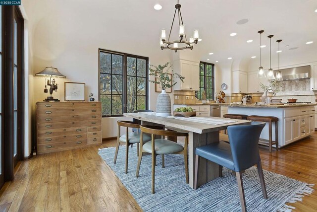 dining room featuring a notable chandelier and light wood-type flooring