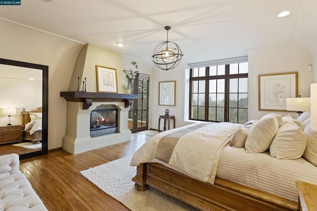 bedroom featuring hardwood / wood-style flooring and a chandelier