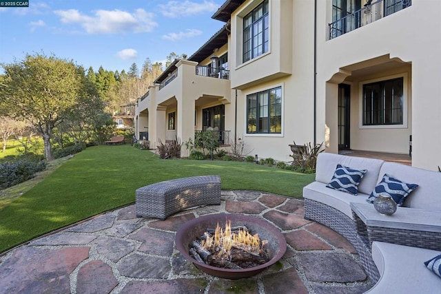 view of patio / terrace with an outdoor living space with a fire pit